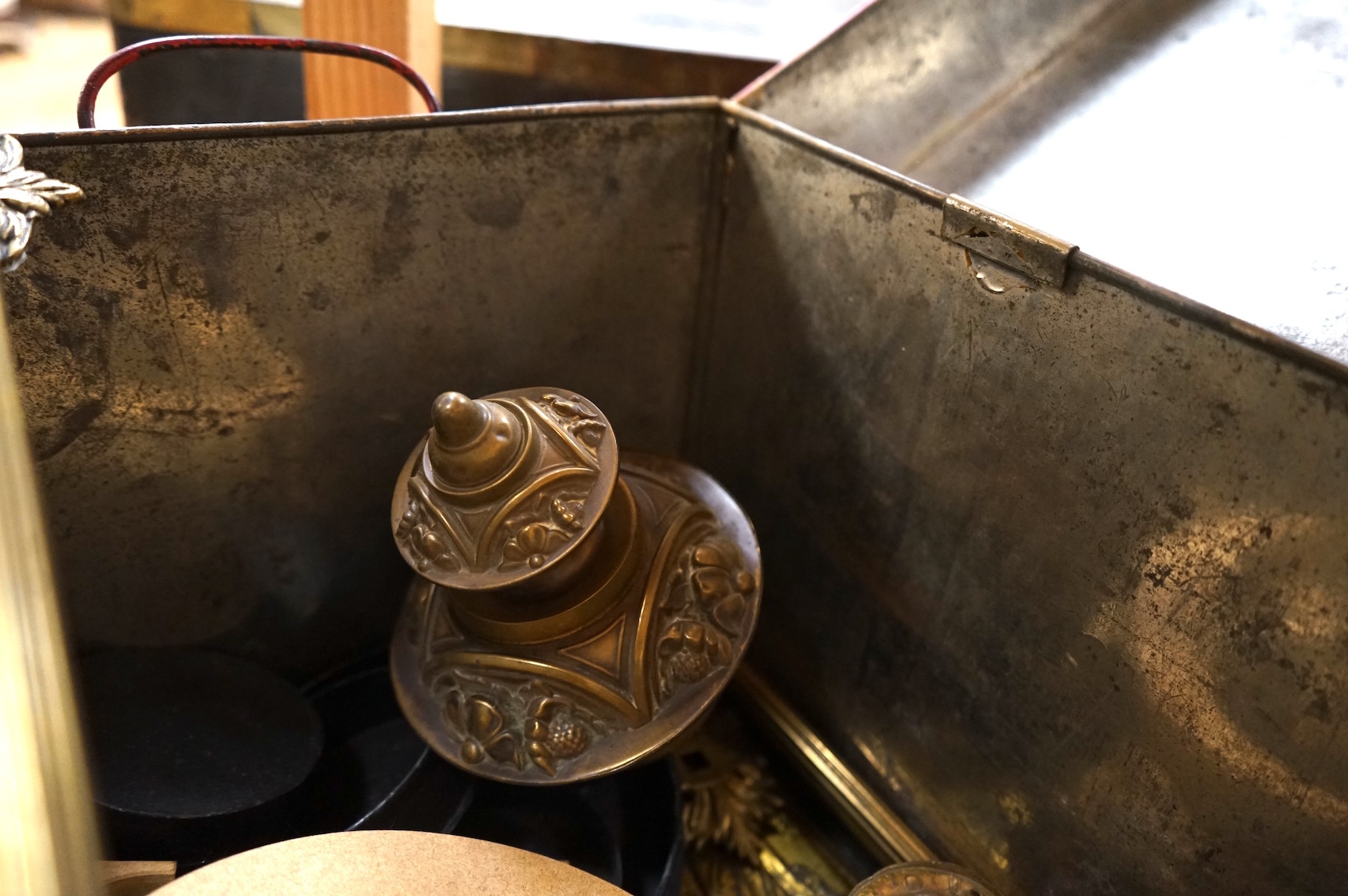 An Anglepoise lamp and metal door furniture and fittings in a tin trunk